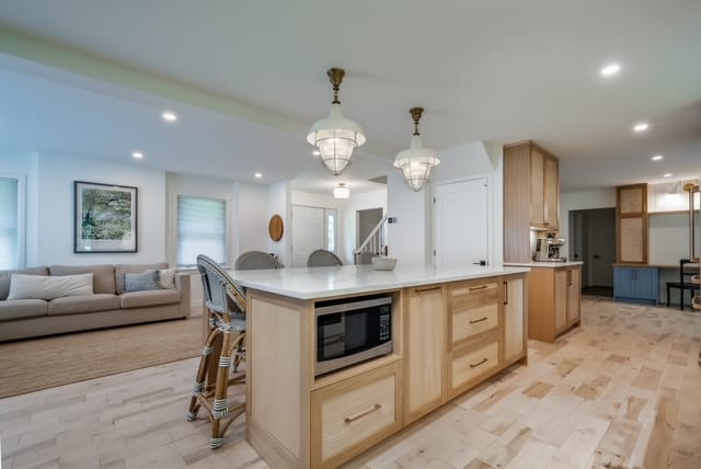 Brass fittings against full-height subway tile — kitchen renovation by Corey Bowen Construction in Hudson, QC