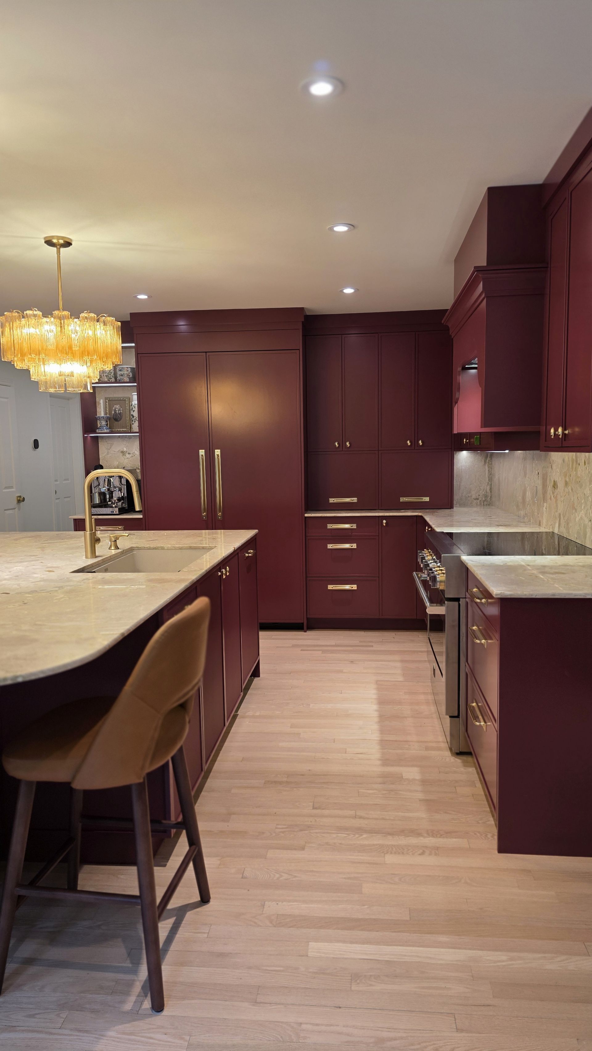 Custom red kitchen cabinets sprayed in a deep red — kitchen renovation by Corey Bowen Construction